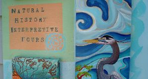 Hand painted sign of blue heron advertising guided interpretative kayak tours. Art work by Hilary Masson