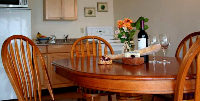 Wooden dining table and chairs in all suites except Suite 6.